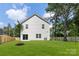 The back exterior view reveals a well-maintained backyard, a patio, and a two-story home at 1141 Thayer Glen Ct, Charlotte, NC 28213
