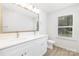 Bathroom with dual vanity, lots of storage, and a large window at 1141 Thayer Glen Ct, Charlotte, NC 28213