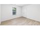 Bedroom featuring light wood-look flooring and a window at 1141 Thayer Glen Ct, Charlotte, NC 28213