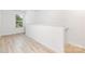 Hallway featuring light wood-look flooring and natural light at 1141 Thayer Glen Ct, Charlotte, NC 28213