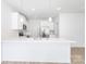 Well-lit kitchen featuring white cabinets, a breakfast bar, stainless steel appliances, and hardwood floors at 1141 Thayer Glen Ct, Charlotte, NC 28213