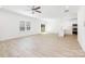 Bright, open-concept living room with wood-look floors and a modern kitchen area at 1141 Thayer Glen Ct, Charlotte, NC 28213