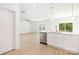Open-concept living space with hardwood floors, and a combined kitchen and dining area bathed in natural light at 1141 Thayer Glen Ct, Charlotte, NC 28213
