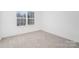 Clean and bright bedroom featuring neutral carpet and a window for natural light at 1144 Thayer Glen Ct, Charlotte, NC 28213