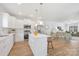 Bright, open kitchen featuring a kitchen island with seating, modern appliances, and wood floors at 1144 Thayer Glen Ct, Charlotte, NC 28213