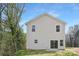 Back of a two-story home showing the vinyl siding, windows, and slider to the patio at 1144 Thayer Glen Ct, Charlotte, NC 28213