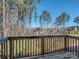 A backyard view from the deck showing the tree line and neighborhood homes at 12214 Ardrey Park Dr, Charlotte, NC 28277