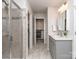 This is a bathroom featuring a glass door shower, closet, and vanity with marble tile floors at 12214 Ardrey Park Dr, Charlotte, NC 28277