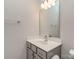 Bathroom featuring gray cabinets, a white counter, and a large mirror at 12214 Ardrey Park Dr, Charlotte, NC 28277