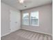 This bedroom features a ceiling fan, 2 large windows for natural light, and a double door closet at 12214 Ardrey Park Dr, Charlotte, NC 28277