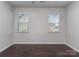 Empty bedroom with hardwood floors and natural light streaming through two windows at 12214 Ardrey Park Dr, Charlotte, NC 28277