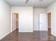Empty bedroom with hardwood floors, two closets and two doorways at 12214 Ardrey Park Dr, Charlotte, NC 28277