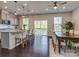 Open-concept dining room with elegant table and chairs, next to an eat-in kitchen at 12214 Ardrey Park Dr, Charlotte, NC 28277