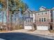 Attractive townhome with stone facade, a two-car garage, and mature trees at 12214 Ardrey Park Dr, Charlotte, NC 28277