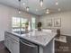 Kitchen island view showcases granite countertops, stainless steel appliances, and an open view to the dining room at 12214 Ardrey Park Dr, Charlotte, NC 28277