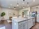 Kitchen island with granite countertops, stainless steel appliances, barstool seating, and an open view to the dining area at 12214 Ardrey Park Dr, Charlotte, NC 28277