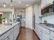 This kitchen features a gas range, stainless steel appliances, light gray cabinetry, and a large island at 12214 Ardrey Park Dr, Charlotte, NC 28277