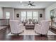 Bright living room featuring stylish seating, a ceiling fan, and large windows at 12214 Ardrey Park Dr, Charlotte, NC 28277