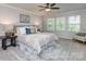 Bright main bedroom with a ceiling fan, decorative pillows, soft rug, and plenty of natural light at 12214 Ardrey Park Dr, Charlotte, NC 28277