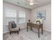 This office features a ceiling fan, 2 large windows for natural light, and a desk and chair at 12214 Ardrey Park Dr, Charlotte, NC 28277