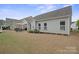 Backyard featuring a well-maintained lawn, outdoor seating, and a view of the home's exterior at 13115 Union Square Dr, Huntersville, NC 28078
