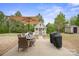 Inviting backyard with a dining table, seating, umbrella, grill, and a charming playhouse at 13115 Union Square Dr, Huntersville, NC 28078