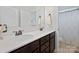 Bathroom featuring a double sink vanity with dark cabinets and a shower with a patterned curtain at 13115 Union Square Dr, Huntersville, NC 28078