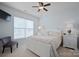 Bright bedroom with a white bed frame, soft carpet, and natural light streaming through the window at 13115 Union Square Dr, Huntersville, NC 28078