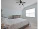 Well-lit bedroom featuring a ceiling fan, large window, and dresser, creating a cozy retreat at 13115 Union Square Dr, Huntersville, NC 28078