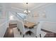 Elegant dining room featuring tray ceiling, chandelier, hardwood floors, and ample seating at 13115 Union Square Dr, Huntersville, NC 28078