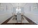Elegant dining room featuring stylish chandelier, tray ceiling, and ample seating at 13115 Union Square Dr, Huntersville, NC 28078