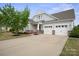 Beautiful home with a welcoming entrance, two-car garage, and a spacious driveway at 13115 Union Square Dr, Huntersville, NC 28078