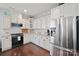This kitchen features white cabinetry, stainless steel appliances, and granite countertops at 13115 Union Square Dr, Huntersville, NC 28078