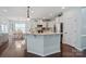 Bright kitchen featuring white cabinetry, granite counters, and a central island, ideal for entertaining at 13115 Union Square Dr, Huntersville, NC 28078