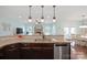 Open concept kitchen with granite countertops, stainless appliances, pendant lighting, and breakfast bar at 13115 Union Square Dr, Huntersville, NC 28078