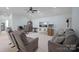 Inviting living room with a ceiling fan, a sofa, and a workspace with a desk and chair at 13115 Union Square Dr, Huntersville, NC 28078