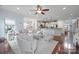 Open-concept living room with a comfortable sectional sofa, hardwood floors, and plenty of natural light at 13115 Union Square Dr, Huntersville, NC 28078
