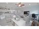 Open-concept living room with hardwood floors, a large sectional sofa, and a view of the kitchen at 13115 Union Square Dr, Huntersville, NC 28078