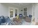 Relaxing covered back porch with comfortable seating, stylish decor, and French doors at 13115 Union Square Dr, Huntersville, NC 28078