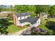 A high-angle view of a two-story home with lawn, patio with fire pit, and colorful landscaping at 1321 South Point Rd, Belmont, NC 28012