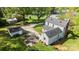 Expansive aerial view of a two-story home with a large yard, fire pit, detached garage, and mature trees at 1321 South Point Rd, Belmont, NC 28012
