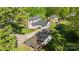 A birds eye view of a two-story home with green lawn, patio area, detached garage, and trampoline at 1321 South Point Rd, Belmont, NC 28012