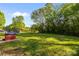 Expansive backyard with mature trees and a trampoline at 1321 South Point Rd, Belmont, NC 28012