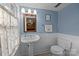 Blue bathroom featuring pedestal sink, white wainscoting, and natural light at 1321 South Point Rd, Belmont, NC 28012