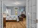 Bedroom with hardwood floors, a decorative chandelier, and natural light coming in from the window at 1321 South Point Rd, Belmont, NC 28012