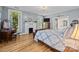 Inviting bedroom with natural light, hardwood floors, fireplace and an adjoining bathroom at 1321 South Point Rd, Belmont, NC 28012