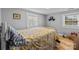 Cozy bedroom with hardwood floors, two windows, and a comfortable-looking bed at 1321 South Point Rd, Belmont, NC 28012