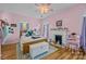 Bedroom featuring a fireplace, wood flooring, and plenty of natural light at 1321 South Point Rd, Belmont, NC 28012