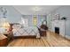 Tranquil bedroom features hardwood floors, fireplace, and large windows at 1321 South Point Rd, Belmont, NC 28012