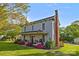 Charming two-story home featuring brick chimney, blossoming trees, and covered front porch at 1321 South Point Rd, Belmont, NC 28012